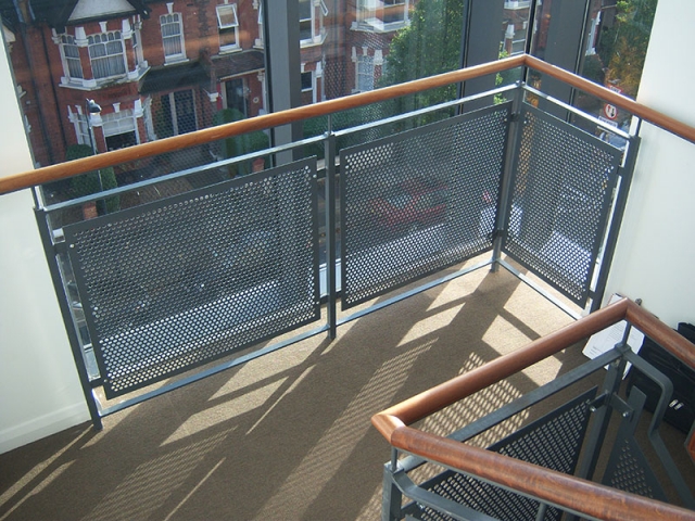 Stairs with perforated sheet infill panels and timber handrail