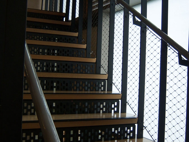 Stairs suspended through 4 floors from the top of the building